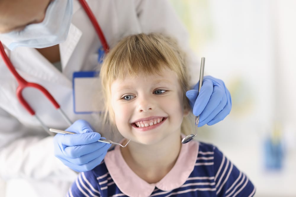 Child receiving dental sealant treatment covered by Blue Cross Blue Shield insurance